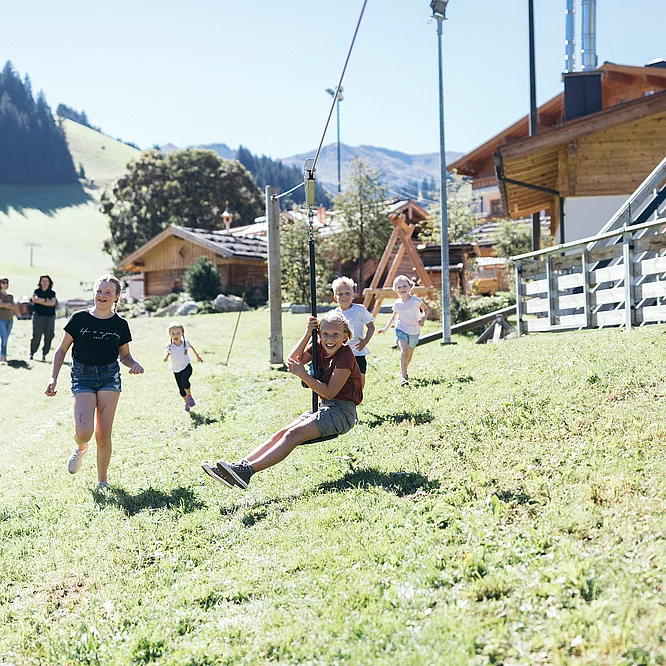 Kids Club & Highlights for teens Children on the playground at the Hotel Unterschwarzachhof in Saalbach Hinterglemm