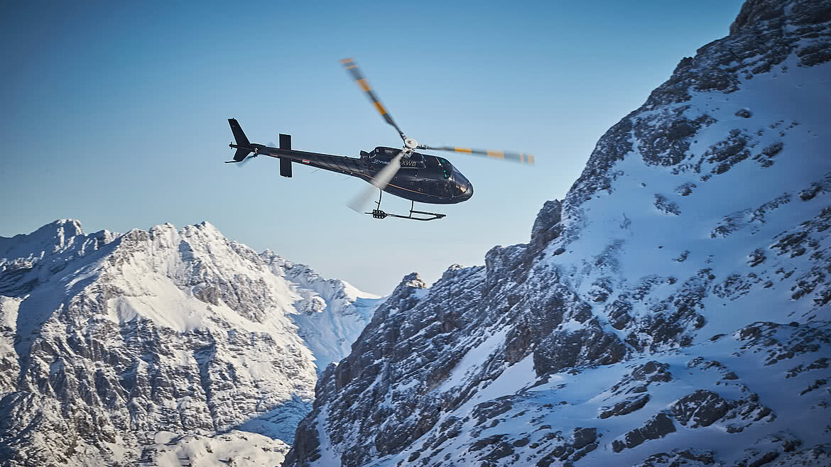Helicopter flight mountains in the winter Sennair