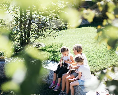 Child with rabbits in the mini farm at the Hotel Unterschwarzachhof