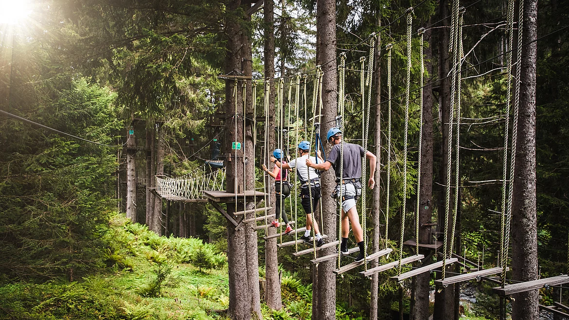 Family on a family holiday at the high ropes course in Saalbach
