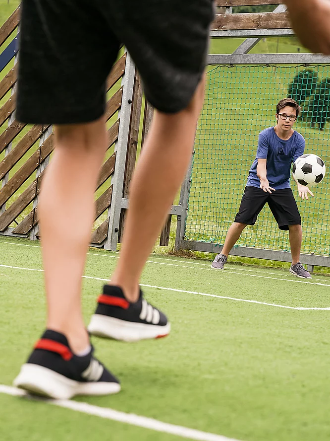 Holiday with teenagers Teenagers playing football in the Hotel Unterschwarzachhof
